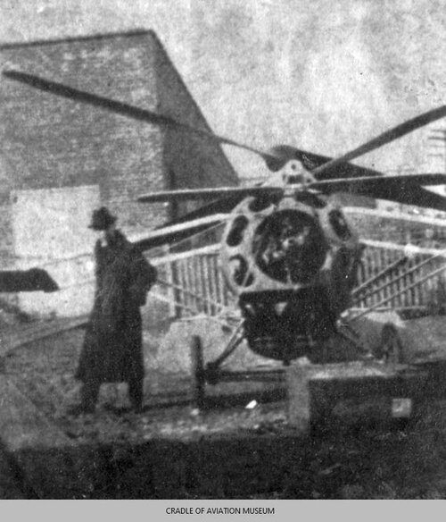 Front view of Helicopter 2 with G. Myers standing next to it.jpg